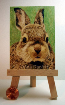 Shown with easel and penny for scale